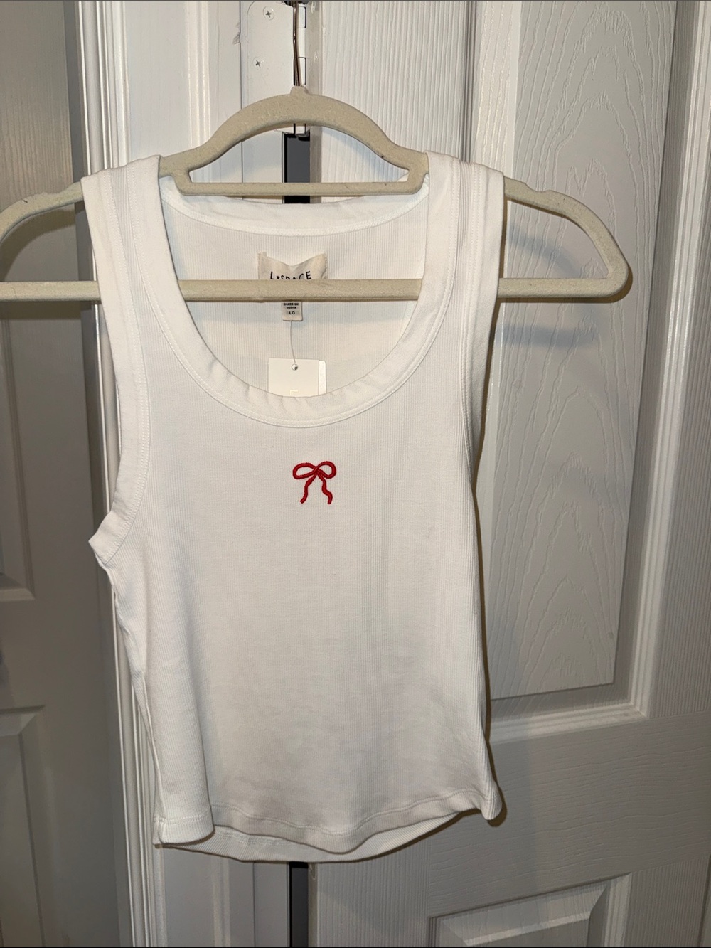 L*SPACE  White Ribbed Tank with Small Pink Accent bow.